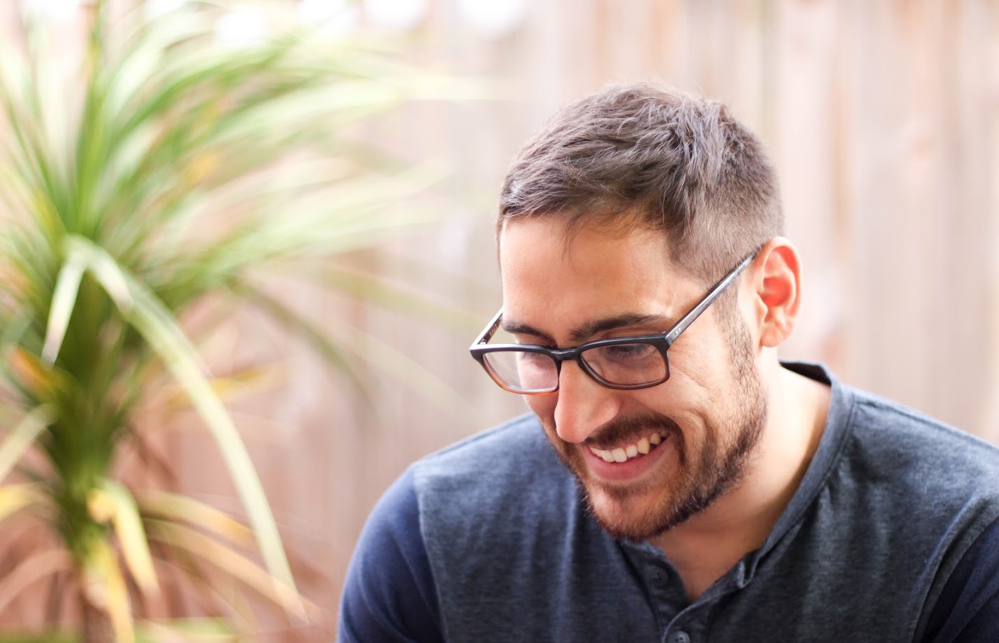 Middle-aged man with glasses looking contemplative, symbolizing the introspection many men undergo when facing symptoms of low testosterone.