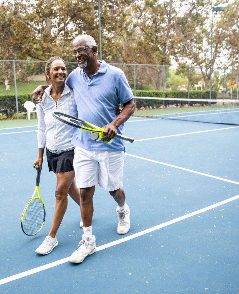Senior Black Couple Walking Off the Tennis Court