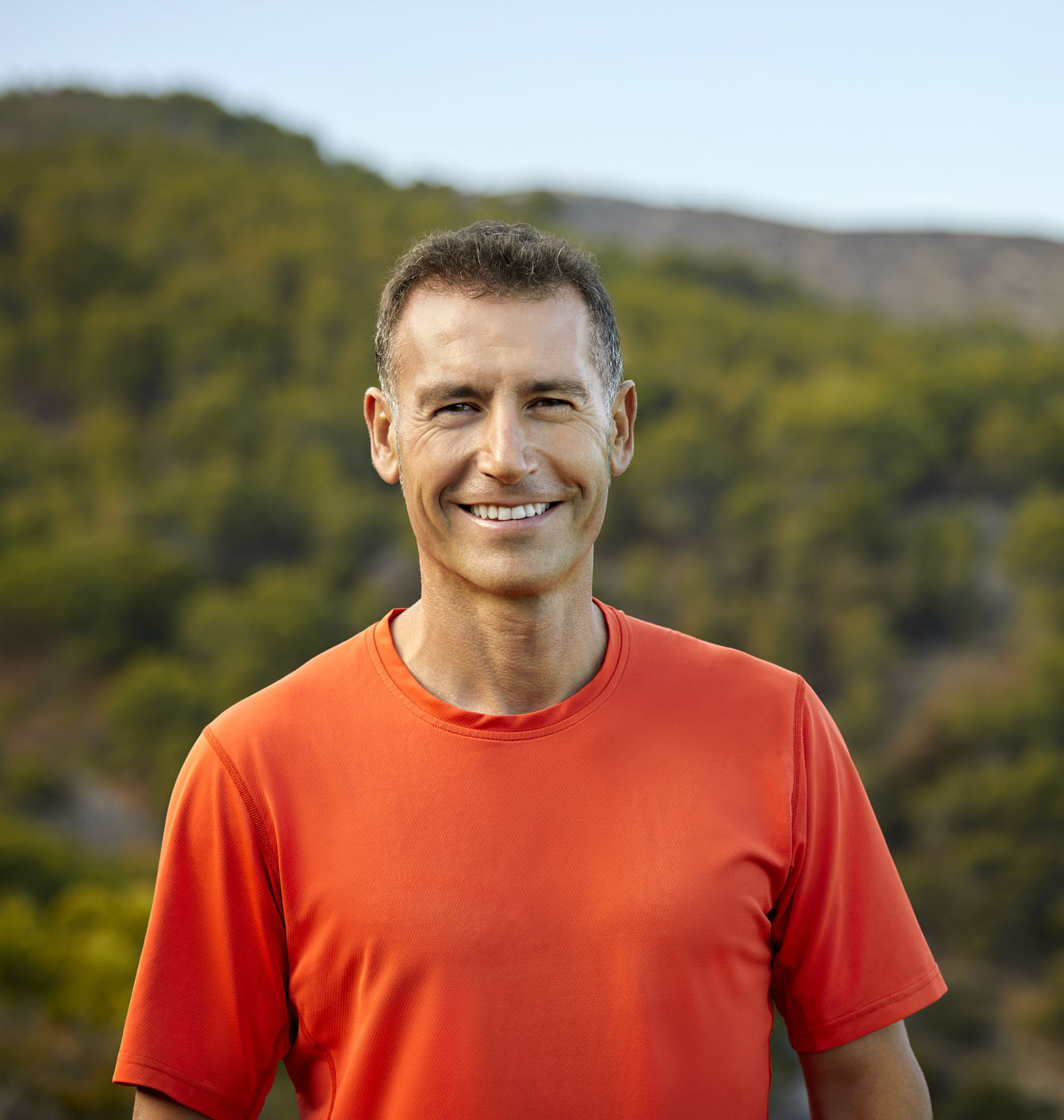 Portrait of smiling mature man against mountain