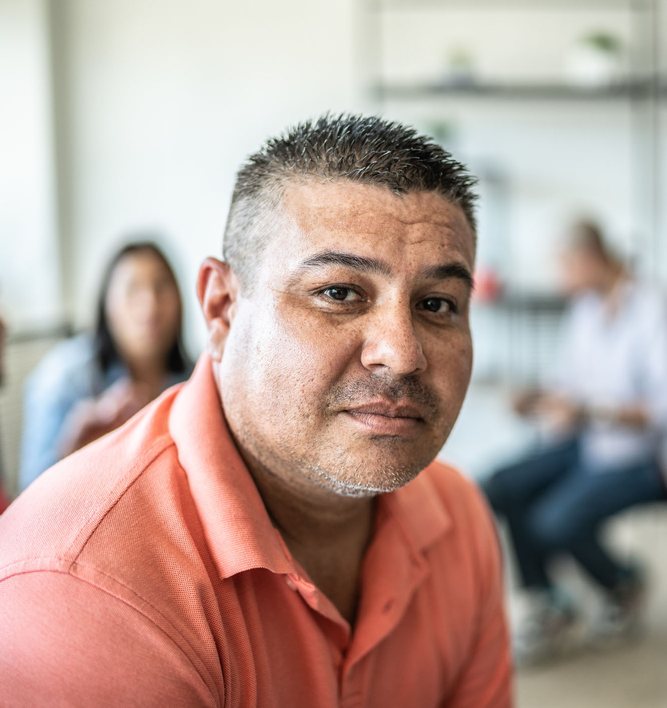Portrait of mid adult man during a group therapy at mental health center