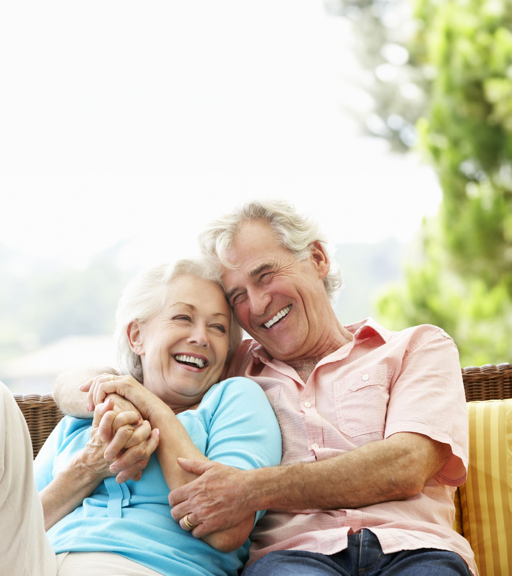 Senior Couple Sitting On Outdoor Seat Together